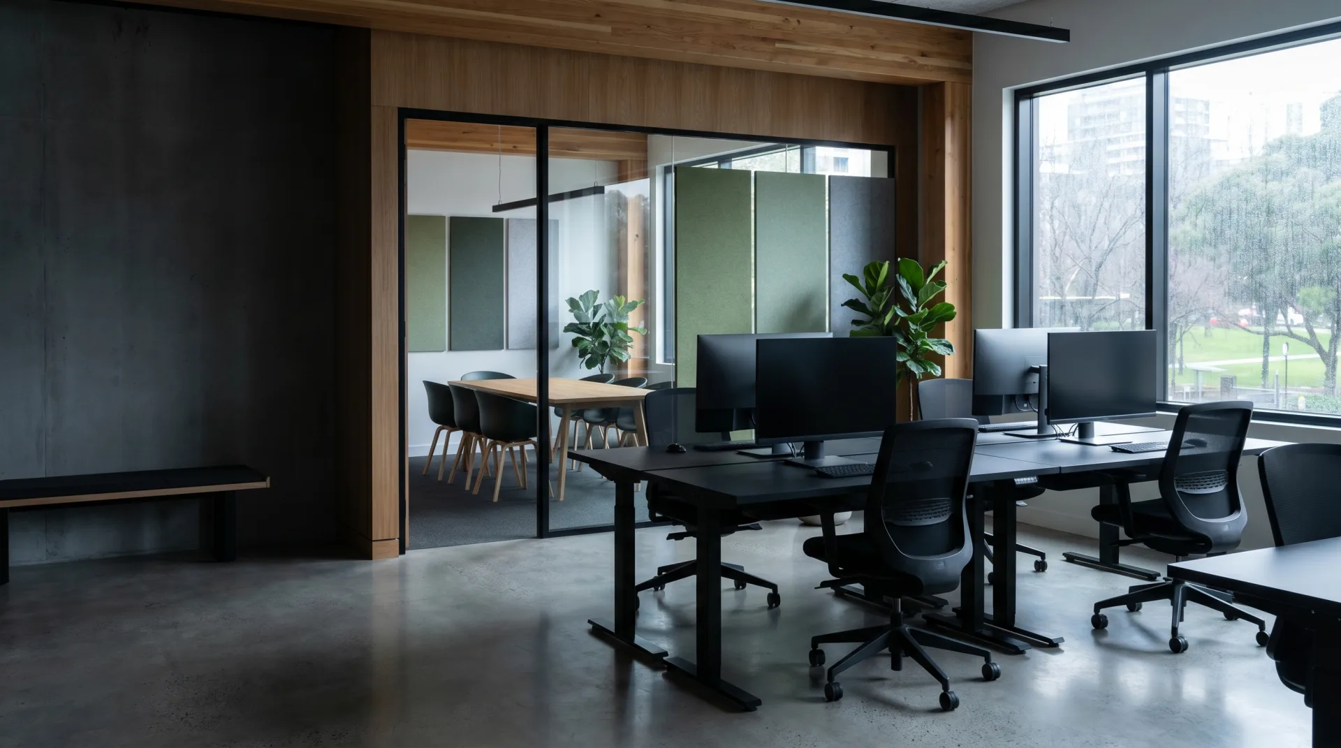 A modern office meeting room with a long oak table and a glass wall onto an open-plan studio, House of Advanced Journal