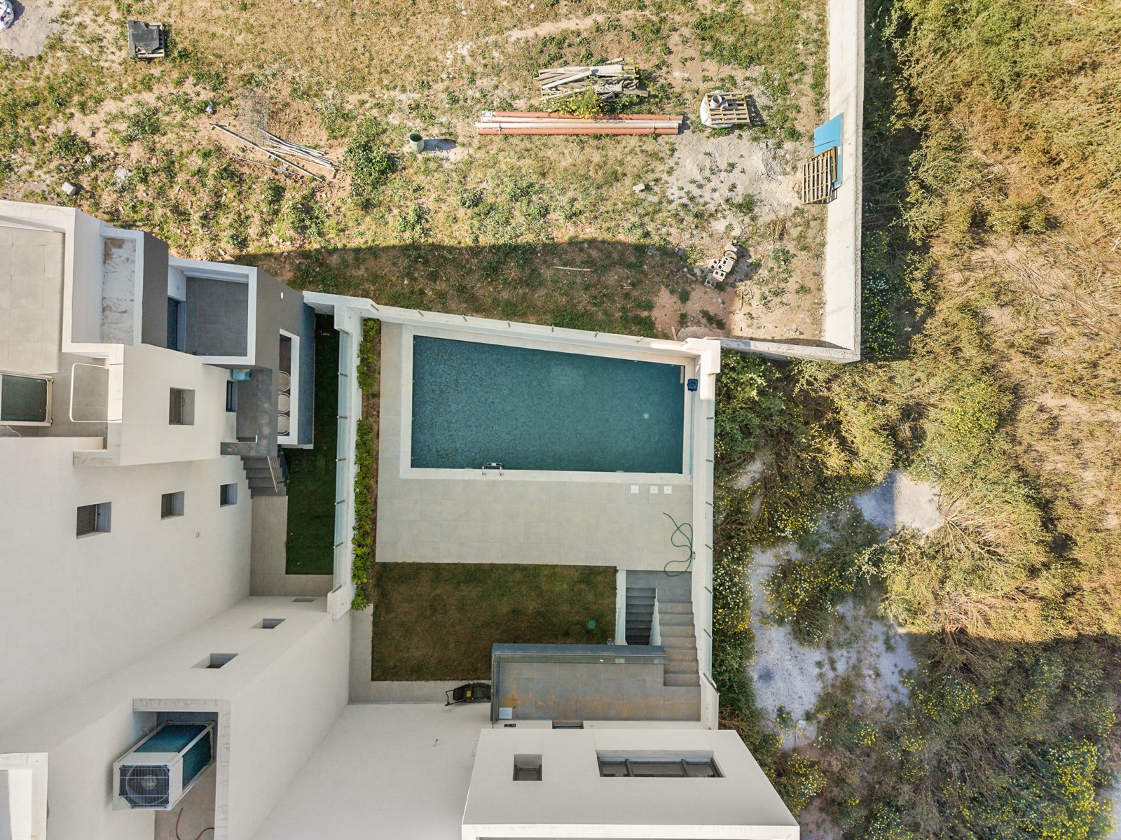 Top-down aerial of the Vari residence and pool