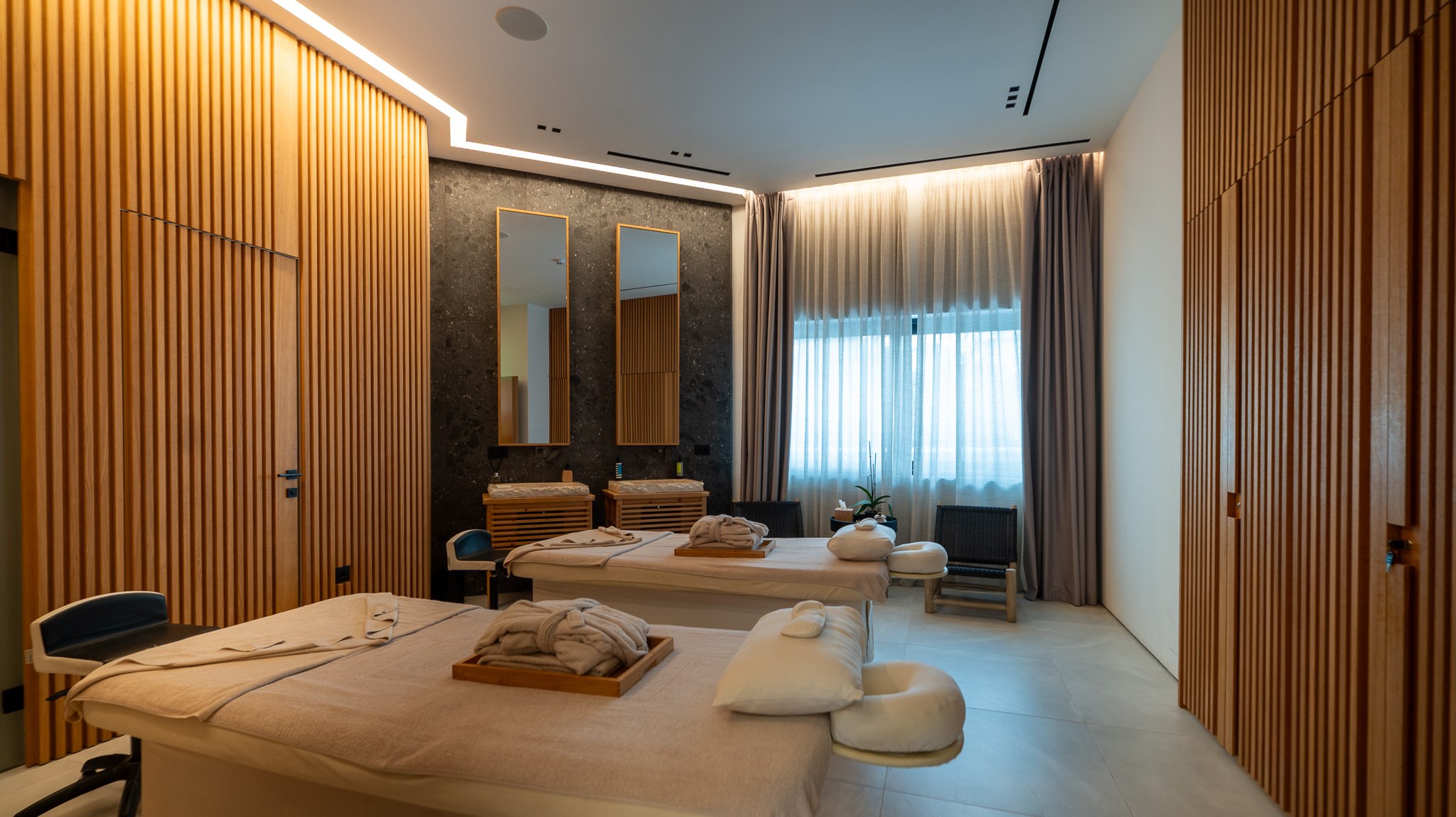 Dusit Suites Athens, spa massage room with twin beds and slatted-oak walls