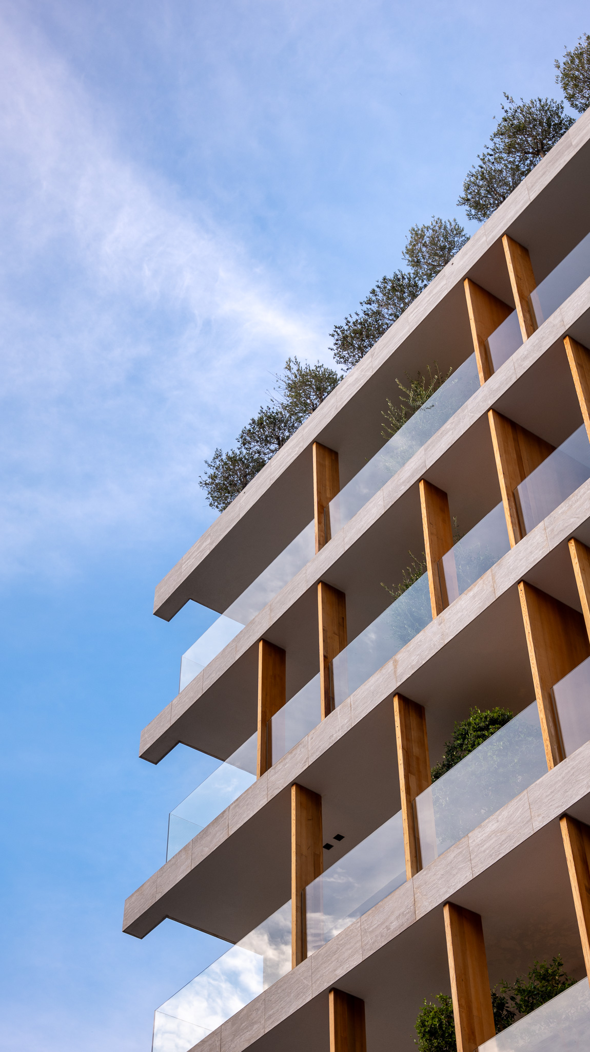 Dusit Suites Athens, vertical stacked-balcony facade with timber fins