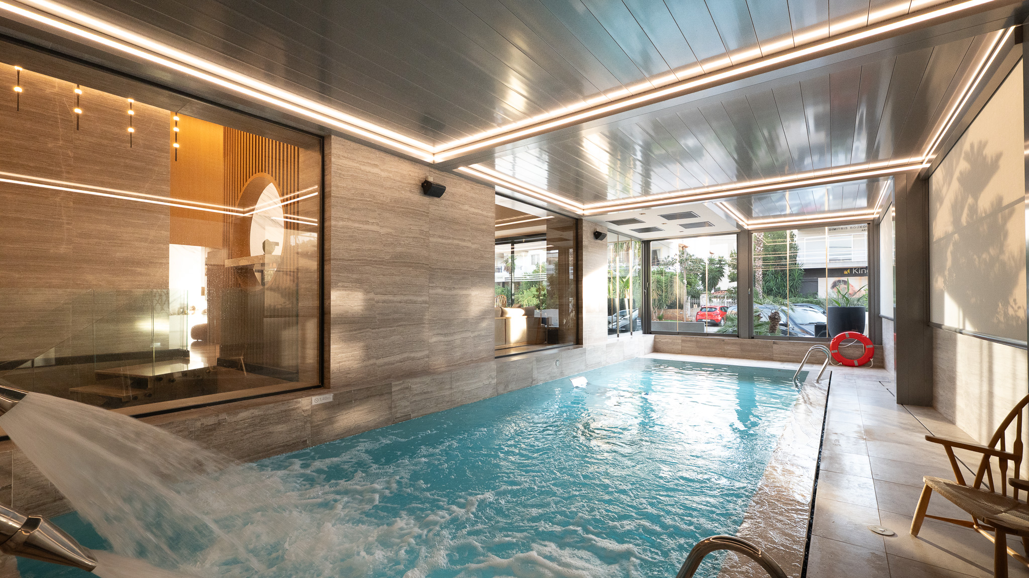Dusit Suites Athens, indoor pool with daylight glazing and wood sauna alcove