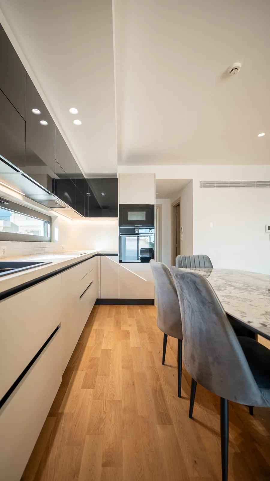 Kitsos Constructions residence, galley kitchen with a marble dining table