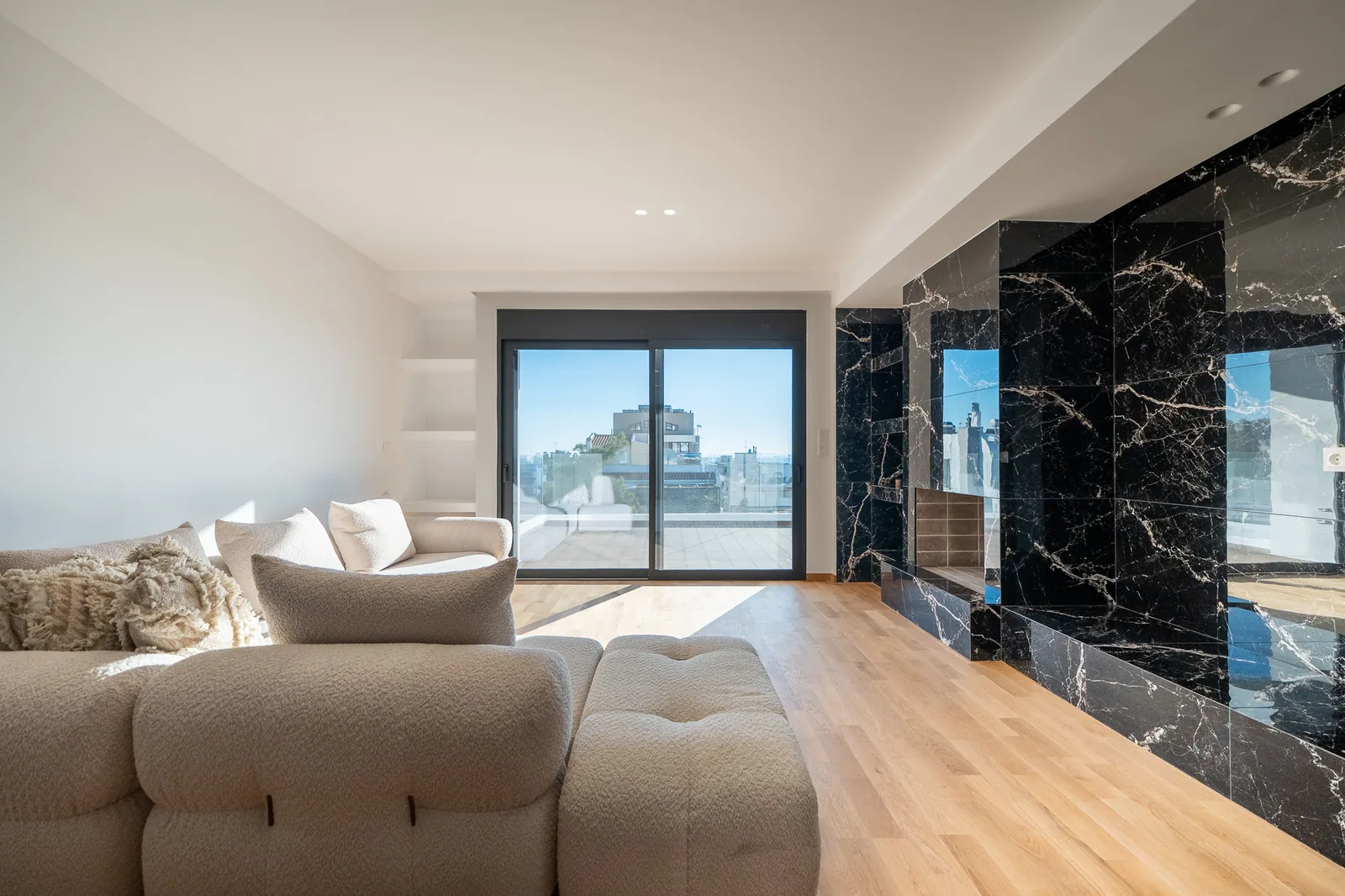 Kitsos Constructions residence, living room with the marble feature wall and terrace
