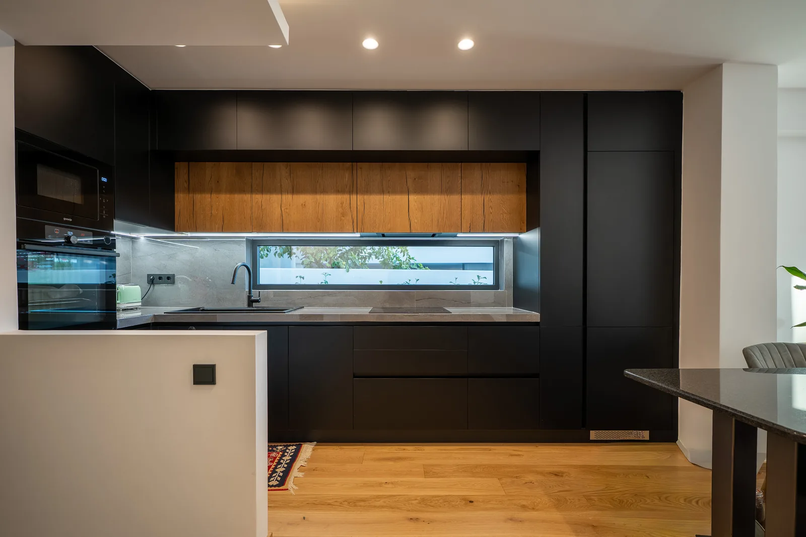 Kitsos Constructions residence, kitchen in black and wood