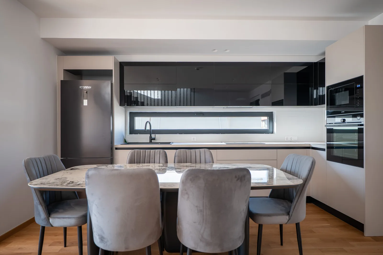 Kitsos Constructions residence, dining area and kitchen with a marble table