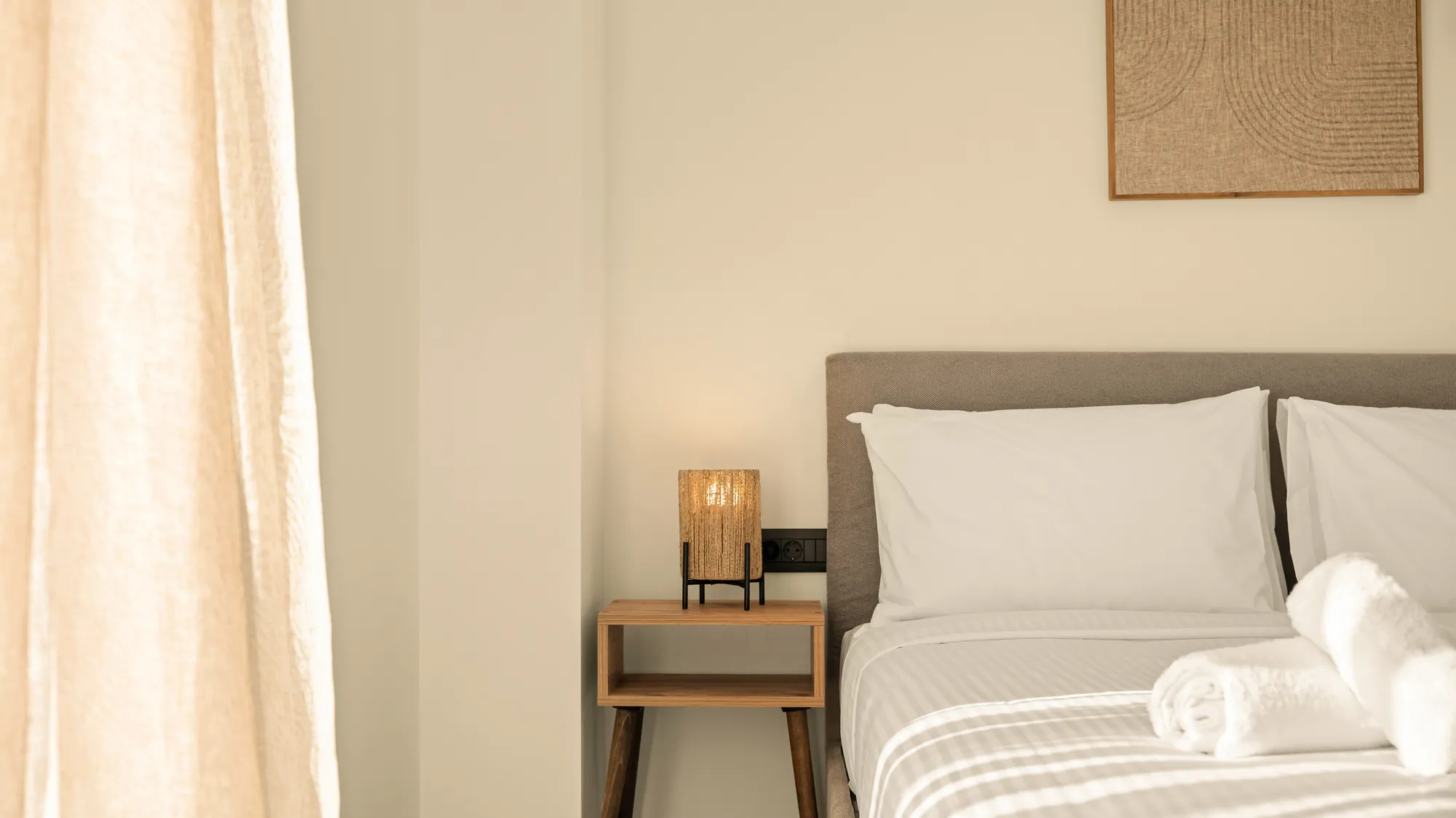 ORMOS Piraeus, the bedside lamp and the grey headboard
