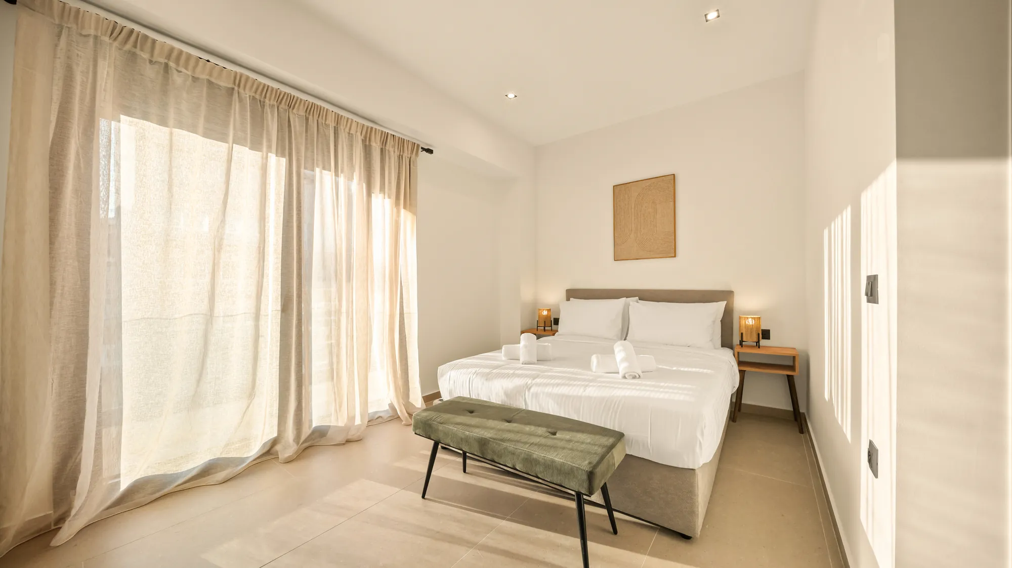 ORMOS Piraeus, a room seen from the corner, curtains drawn back to the balcony