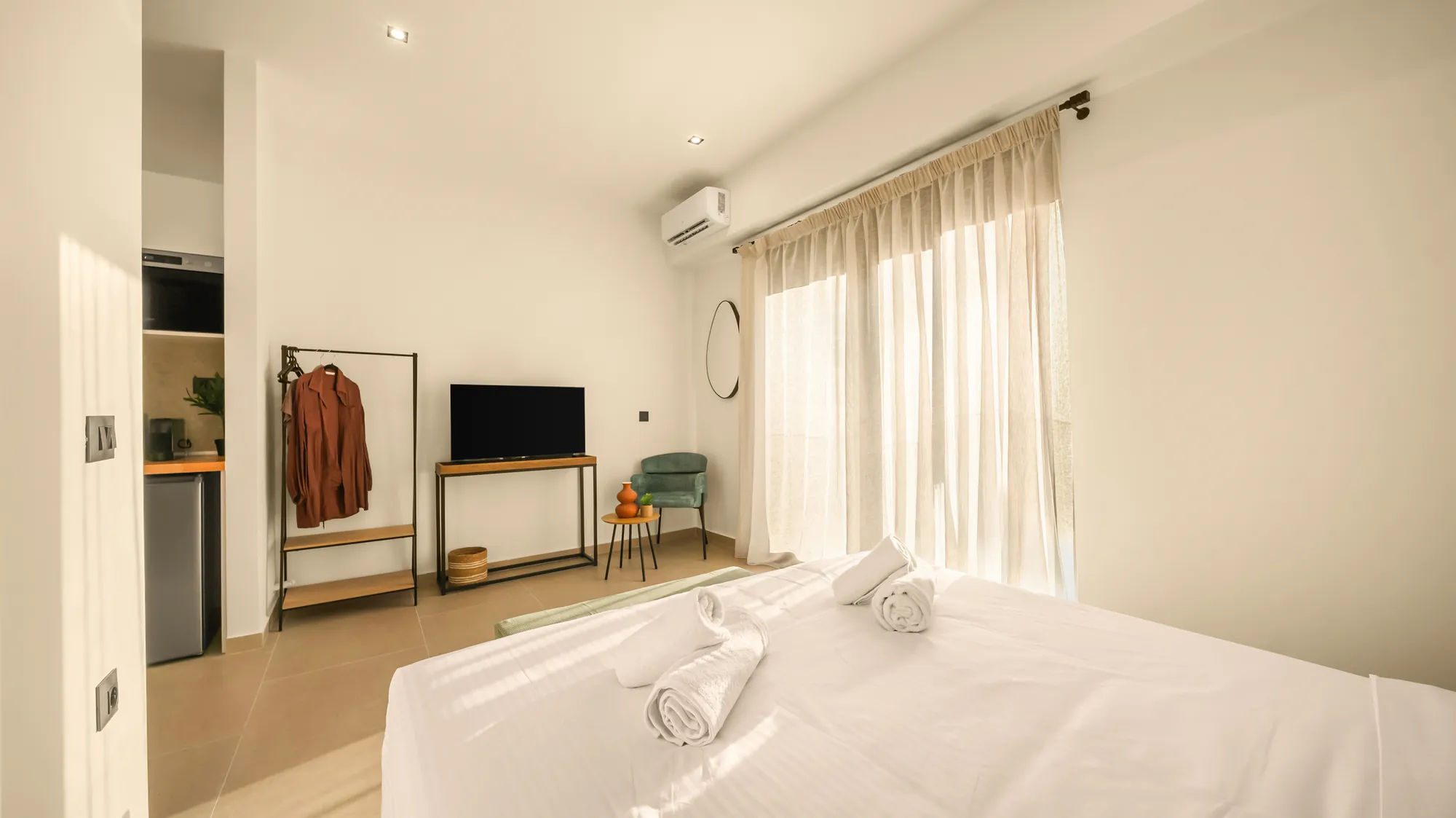 ORMOS Piraeus, the room from the bed toward the clothes rail and the television