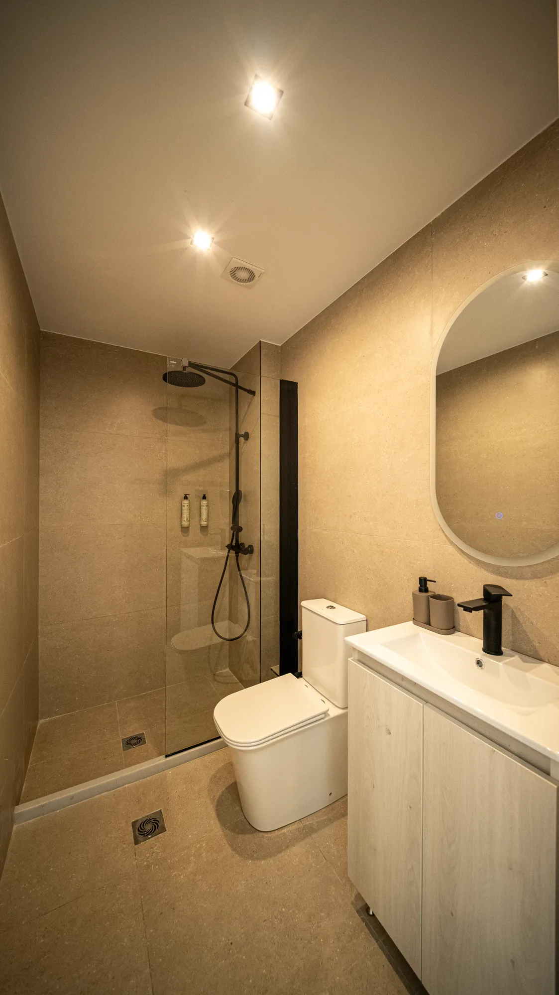 ORMOS Piraeus, the bathroom with the walk in rain shower and the oval mirror