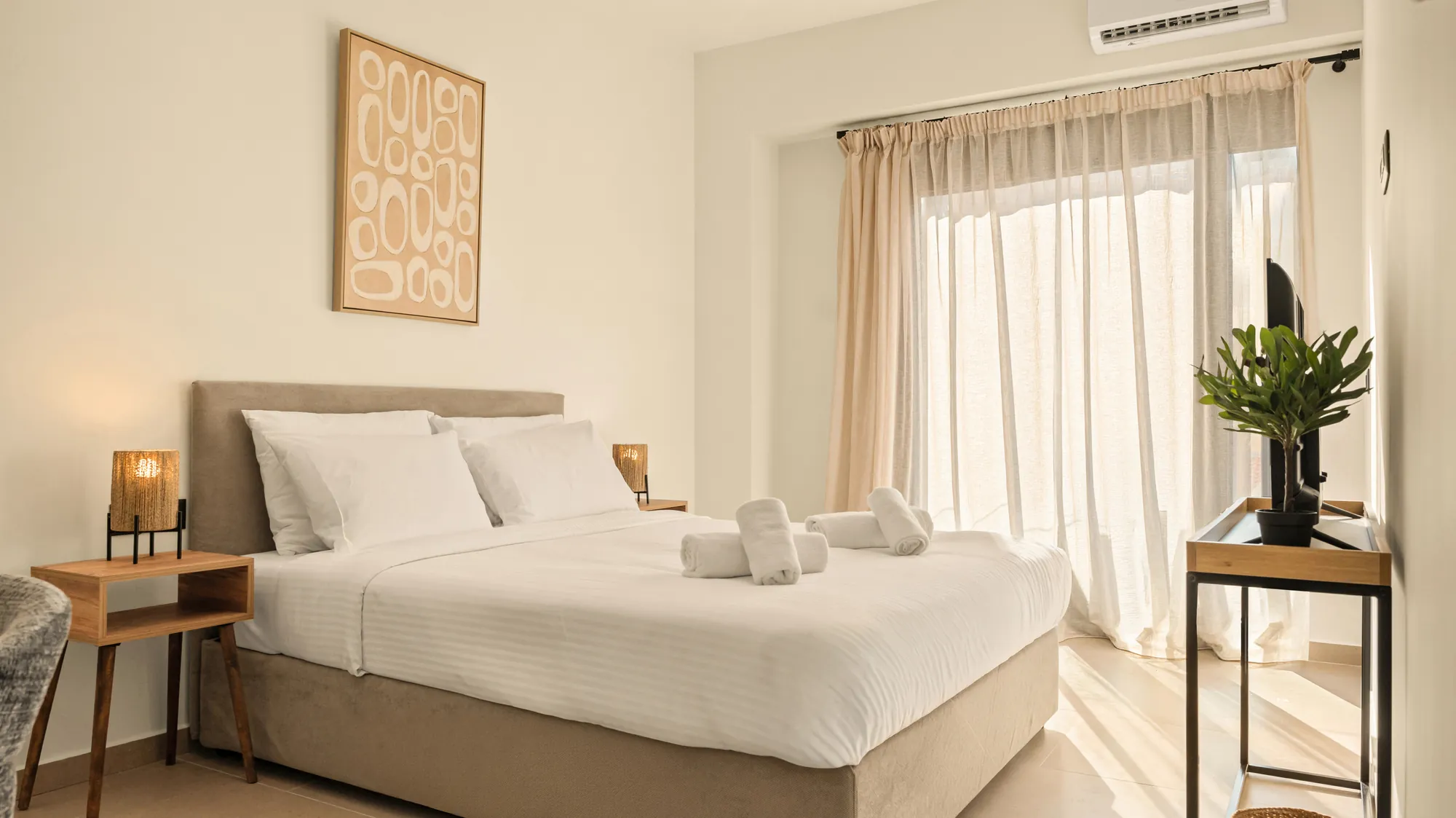 ORMOS Piraeus, a room in morning light with an olive tree by the window