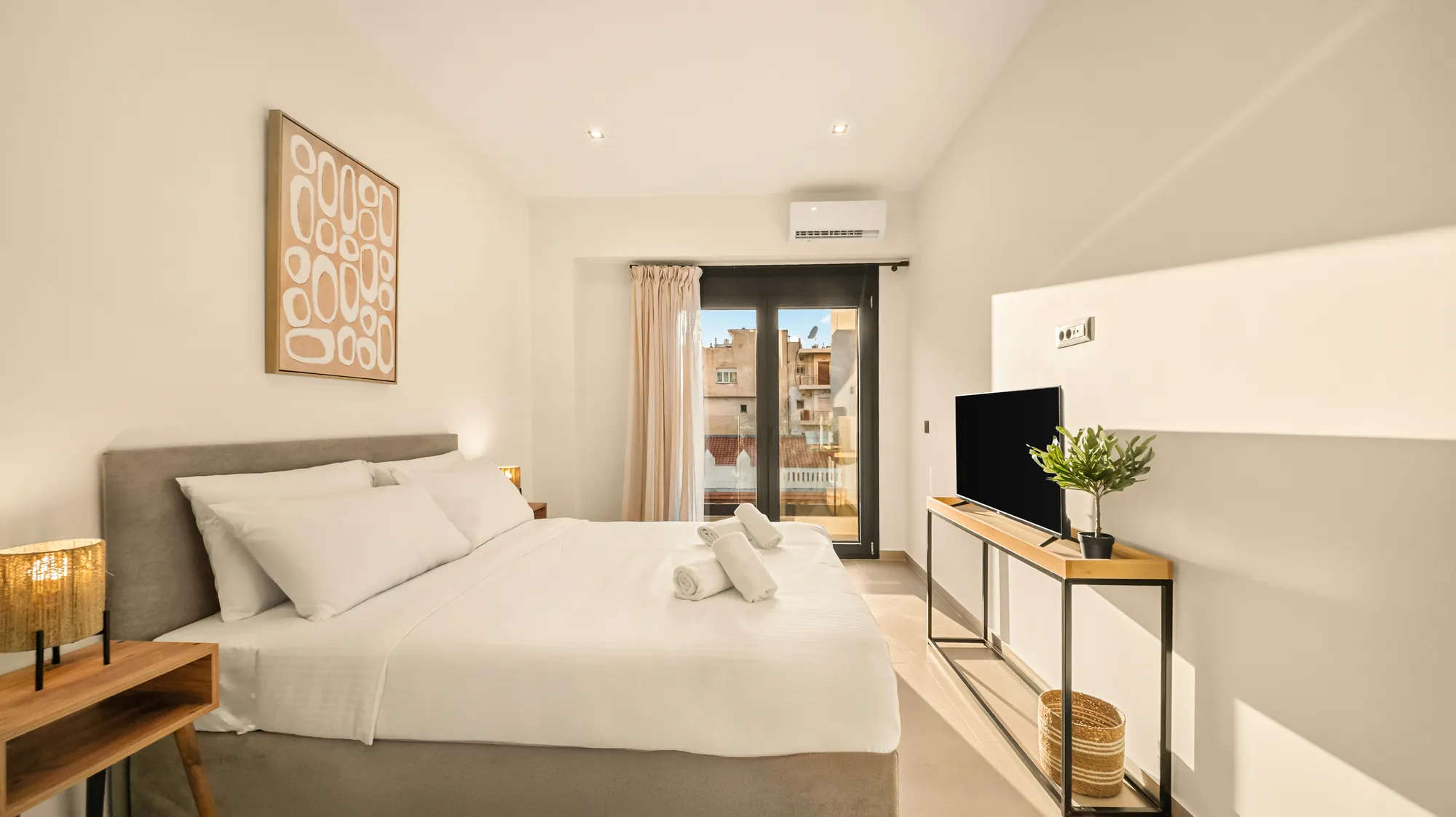 ORMOS Piraeus, a room with the balcony doors open to the city