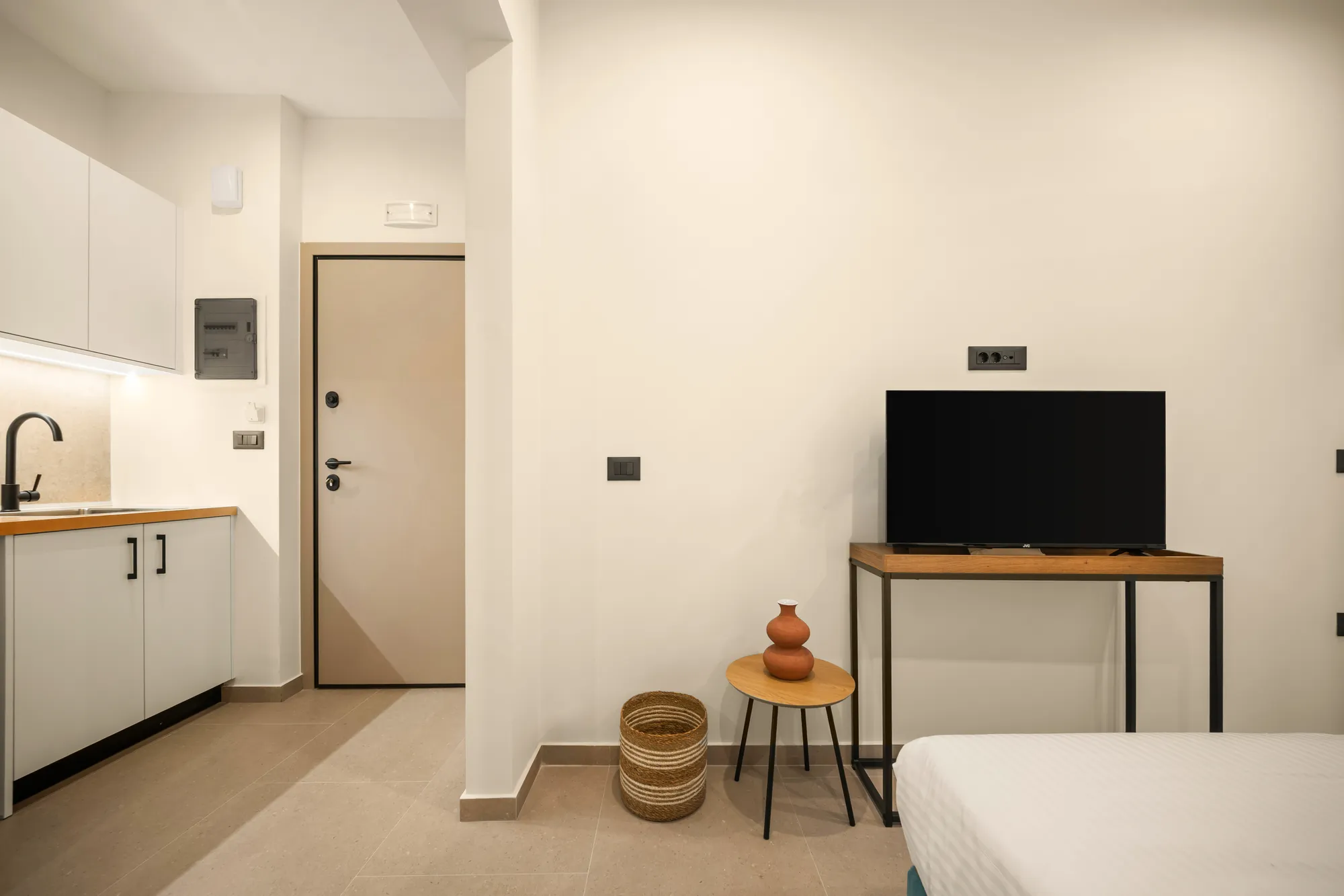 ORMOS Piraeus, the kitchenette and the entrance door, seen from the bed