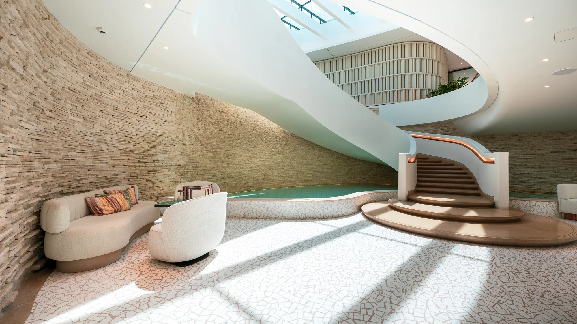 One&Only Aesthesis, the lobby lounge with curved stone walls and the staircase