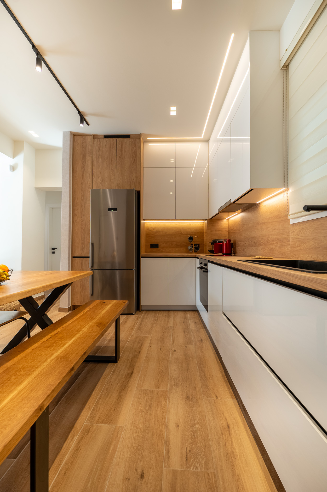 A&K Chorothetisis, galley kitchen looking down corridor with LED-lit cabinetry