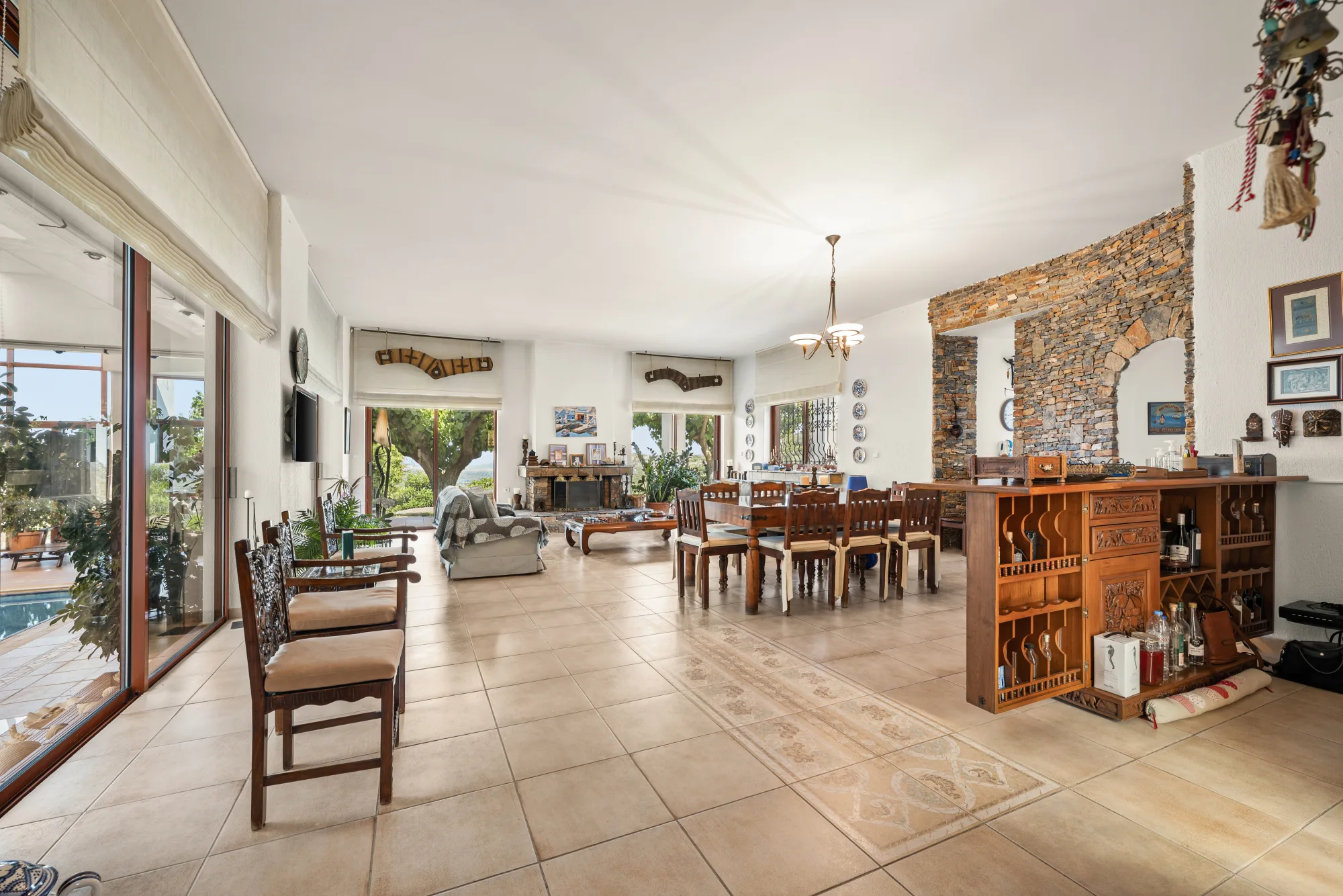 Verde Vista, open living and dining space with a stone feature and long view