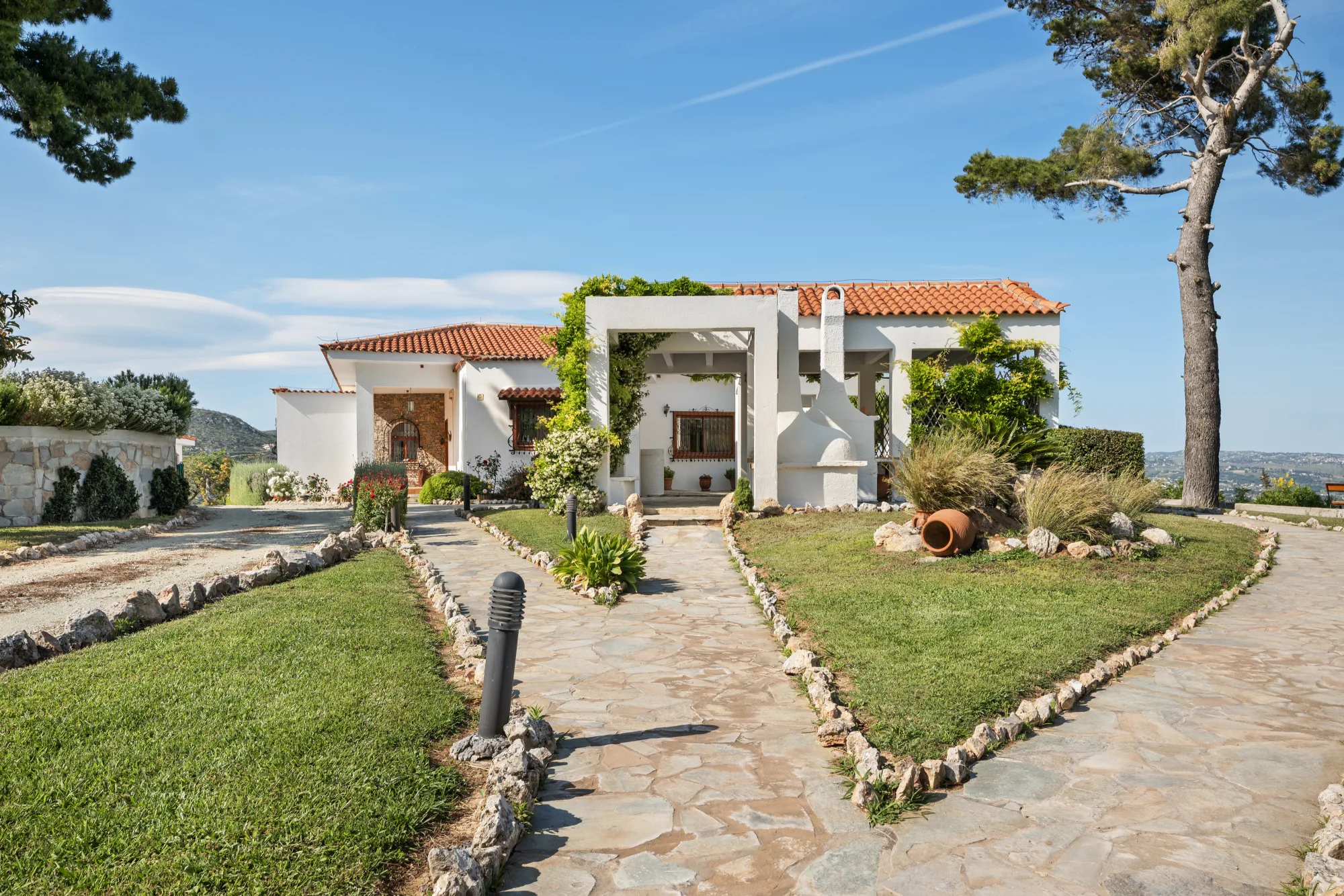 Verde Vista, the estate framed by pines above its grounds in Afidnes
