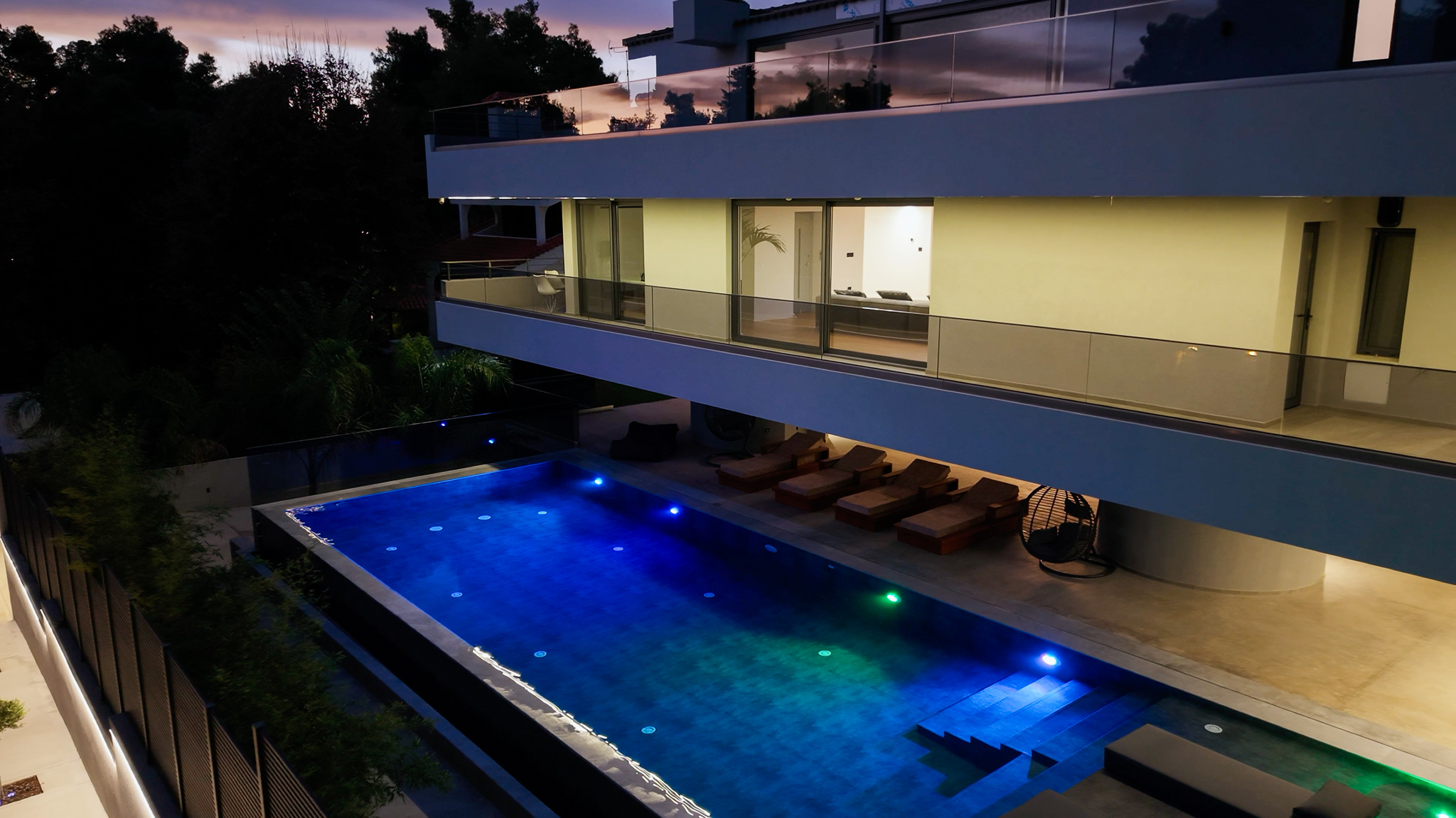 Villa Bond, twilight aerial bridging into the next register