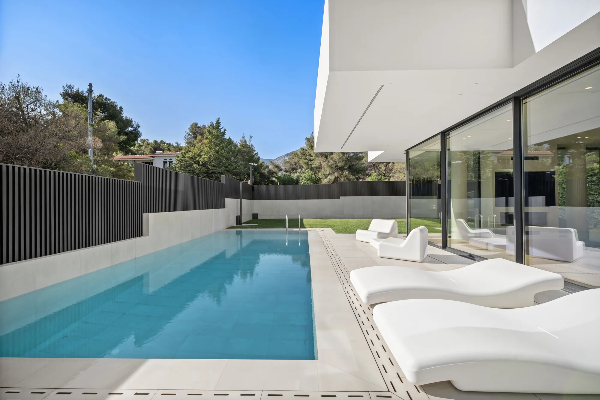 Villa Eden, poolside loungers beside the villa