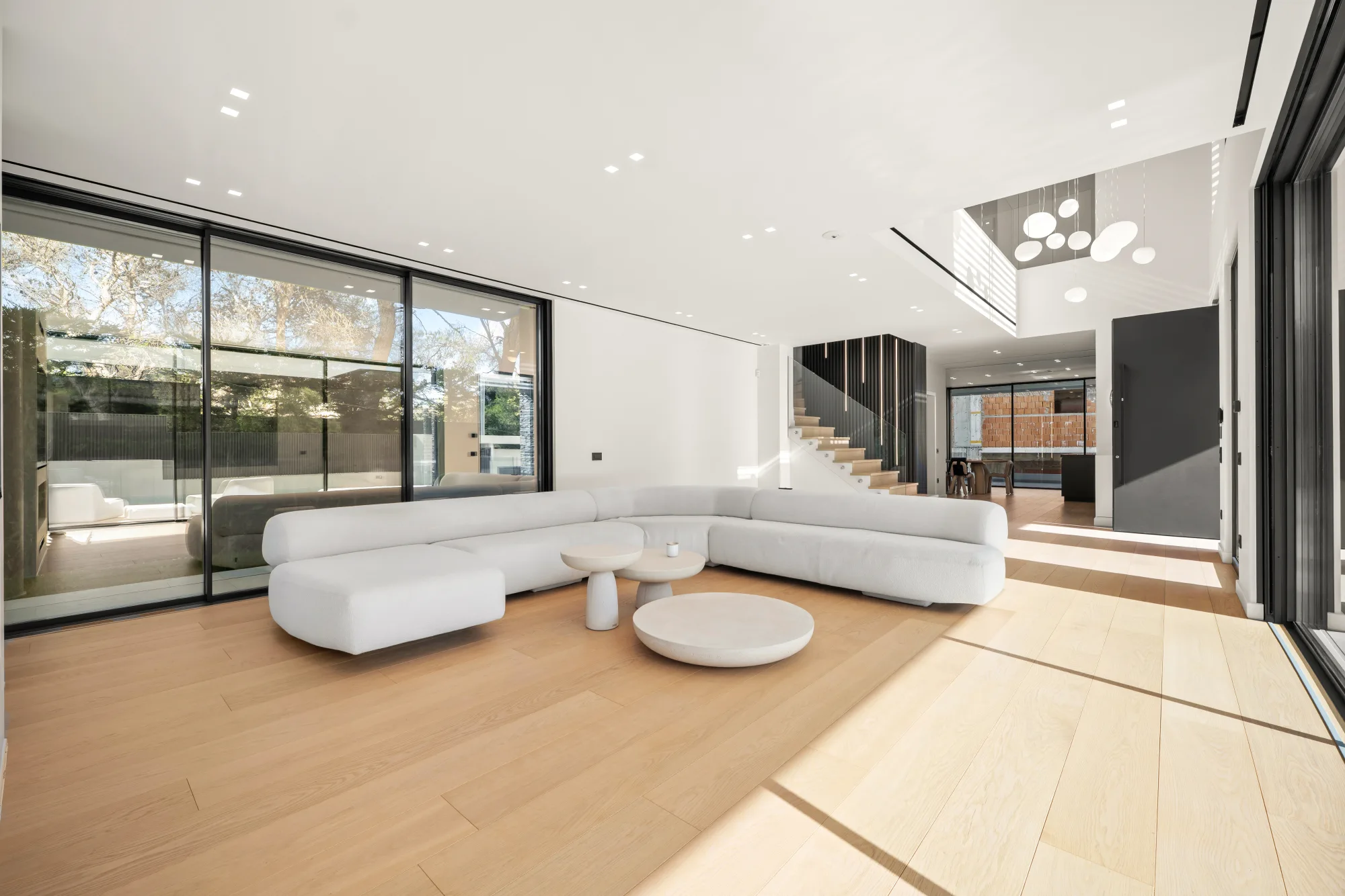 Villa Eden, open living room with sofa, staircase and chandelier