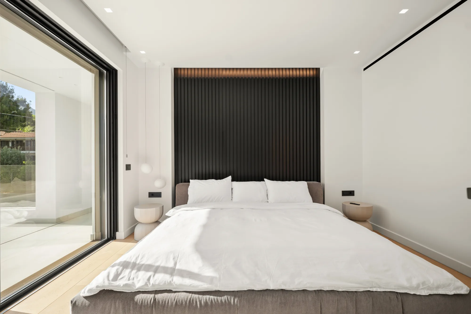 Villa Eden, bedroom with dark timber headboard wall