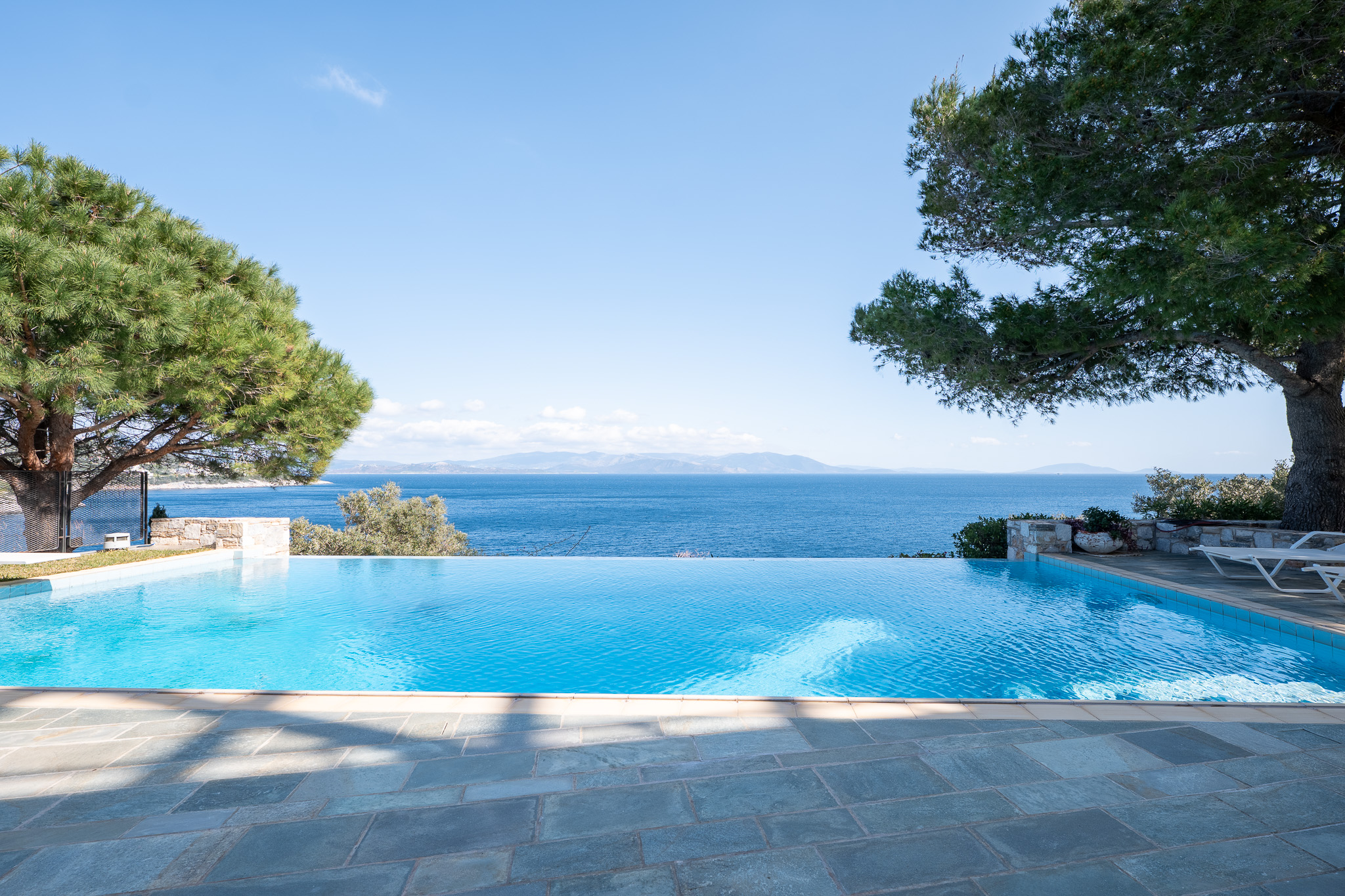 Villa Selene, infinity pool framed by pines with sea horizon