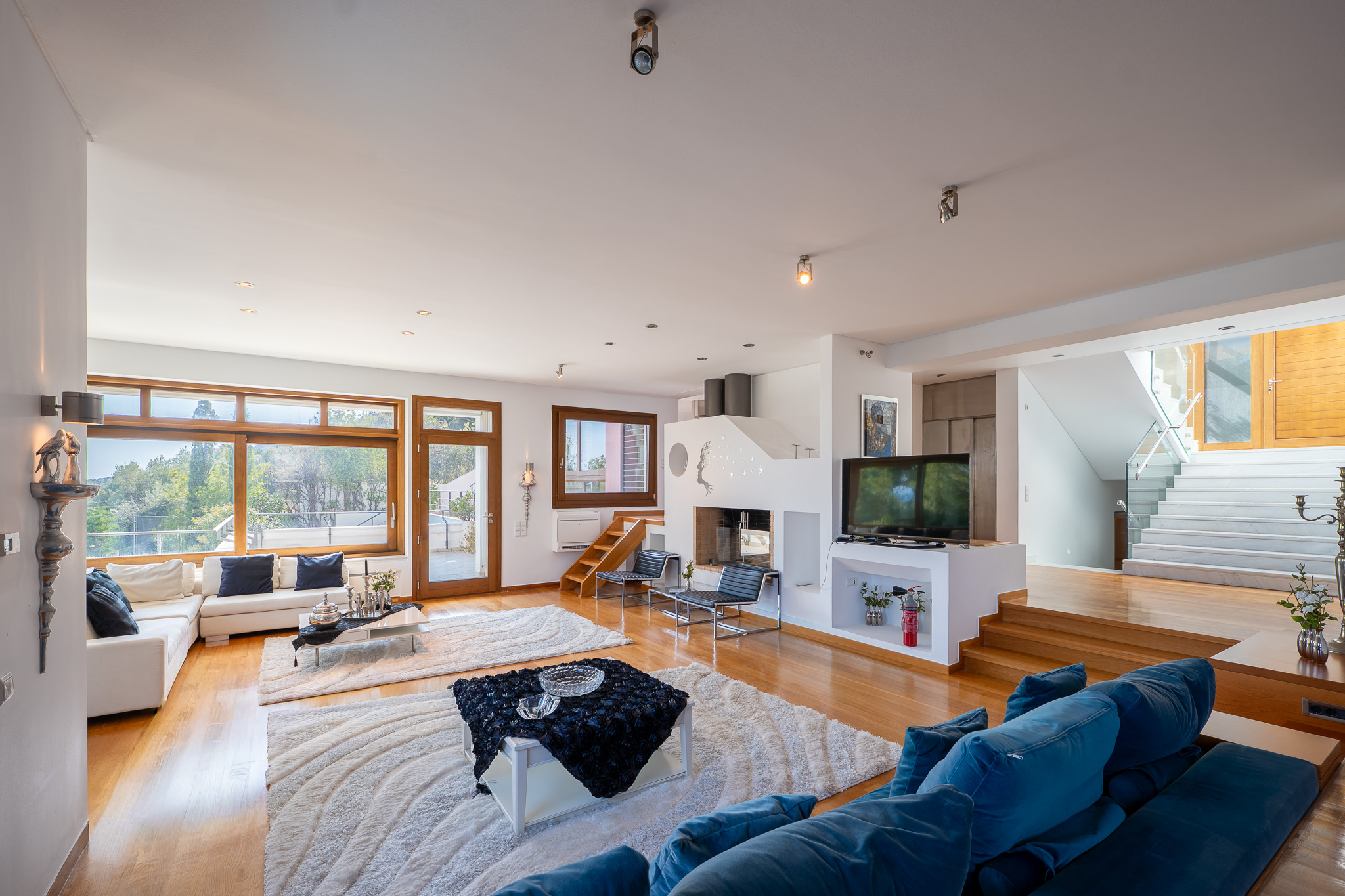 Villa Selene, high-ceiling living room with feature fireplace