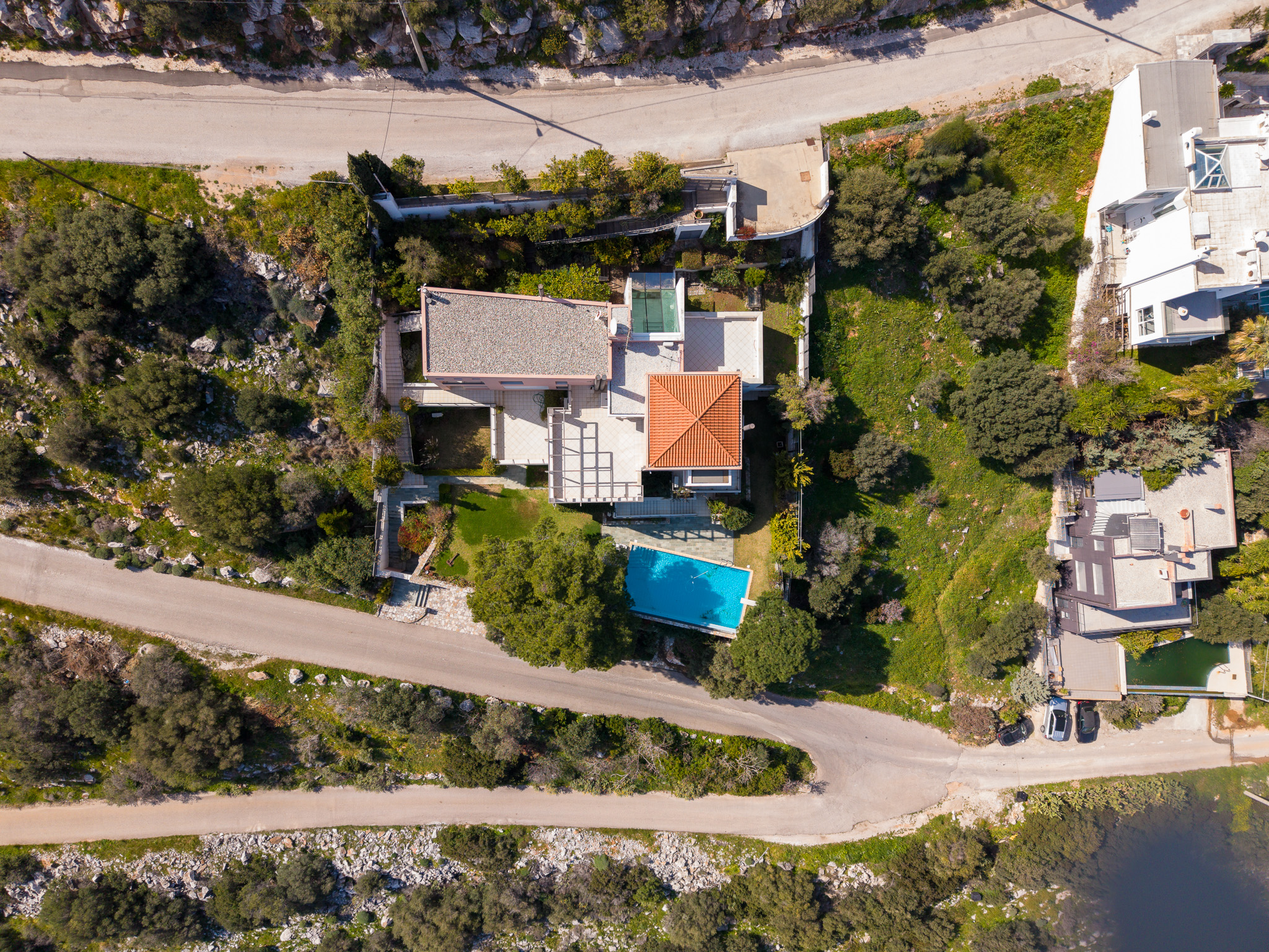 Villa Selene, elevated aerial of villa with neighbours and the sea edge