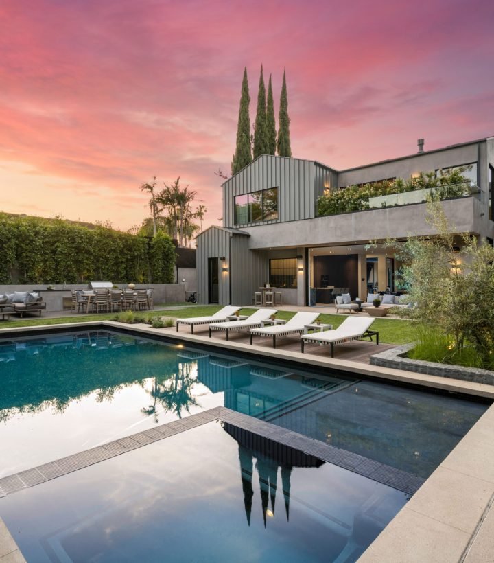 Luxury home with pool at sunset